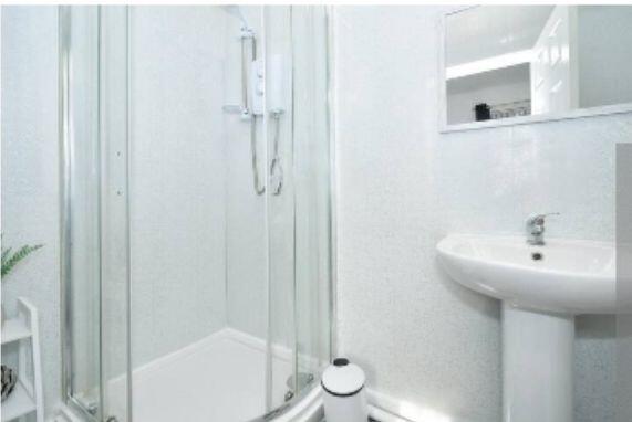 A clean and modern bathroom with a compact show...