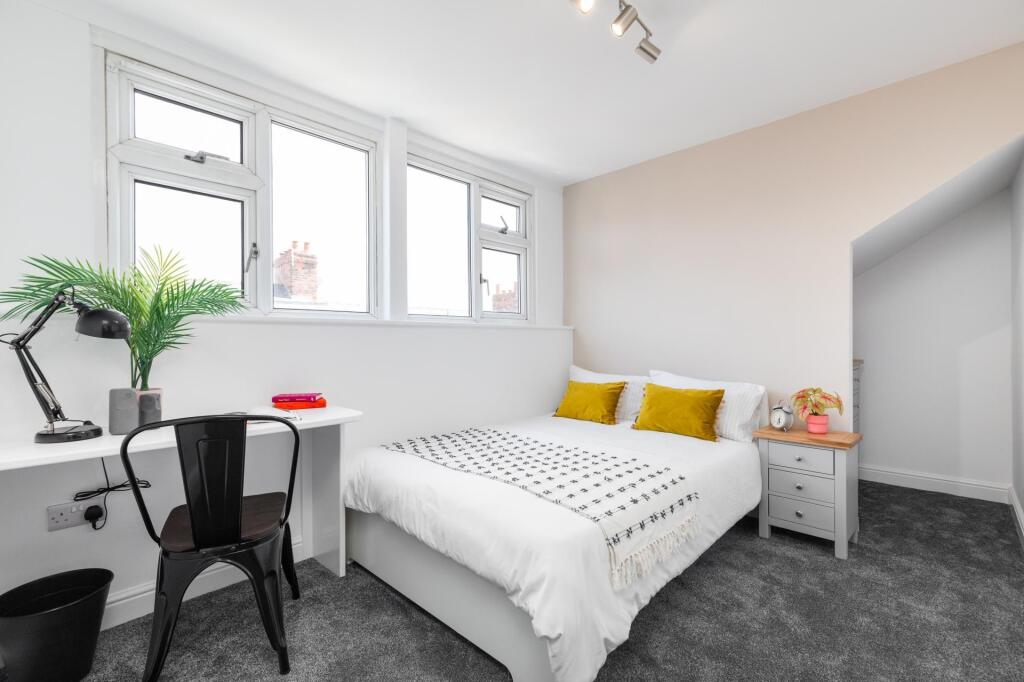 Bright and spacious master bedroom featuring a ...
