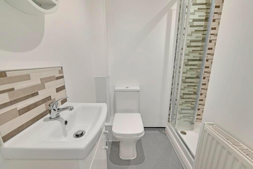 A modern and bright bathroom featuring a clean ...
