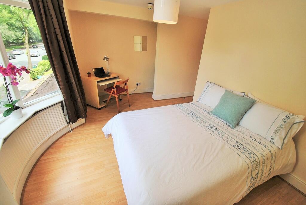 A bright and inviting double bedroom featuring ...