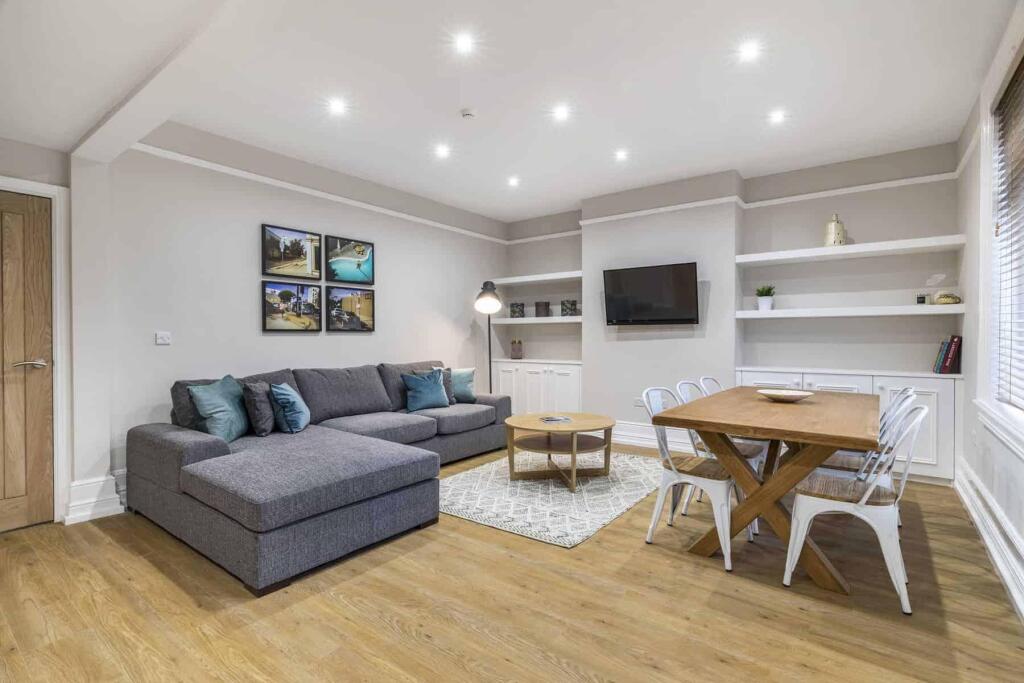 Bright, modern living room with a large L-shape...