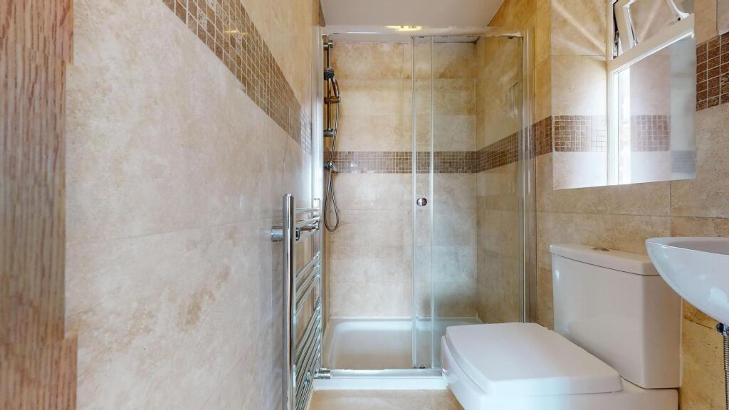 Bright and clean bathroom featuring a walk-in s...