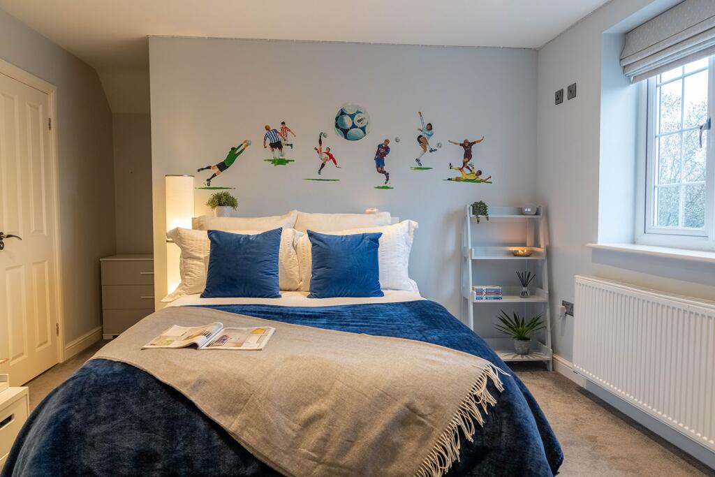 Bedroom 2 with walk in wardrobe behind the bed head