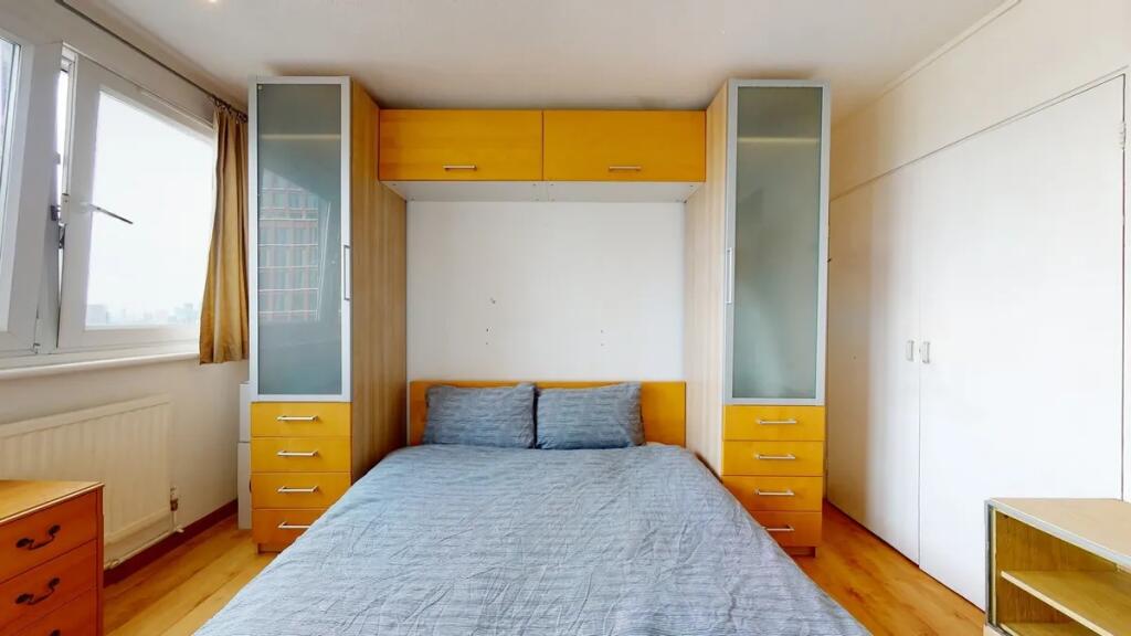 Bright and tidy double bedroom featuring a comf...
