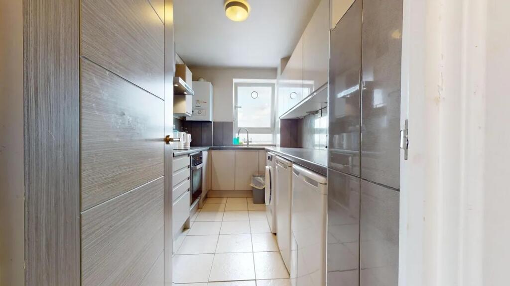 Bright and modern kitchen featuring ample count...