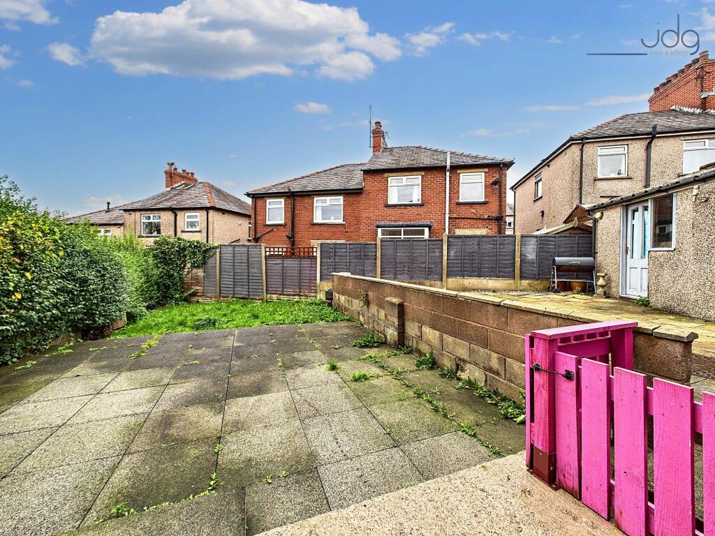 Spacious Garden with a mixture of flags and green grass