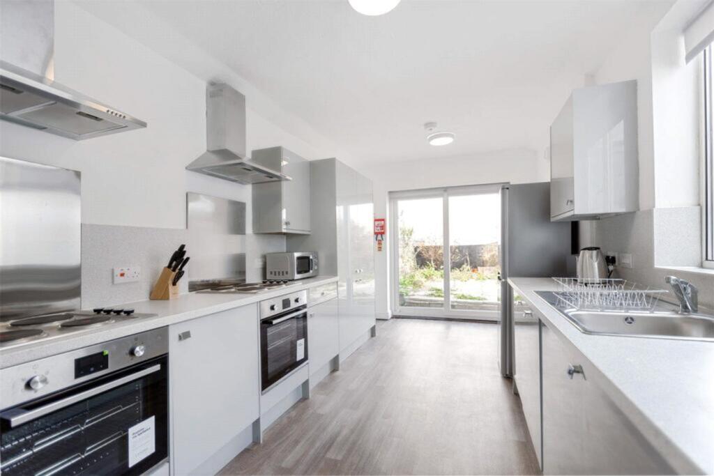 Modern and spacious kitchen featuring sleek cab...