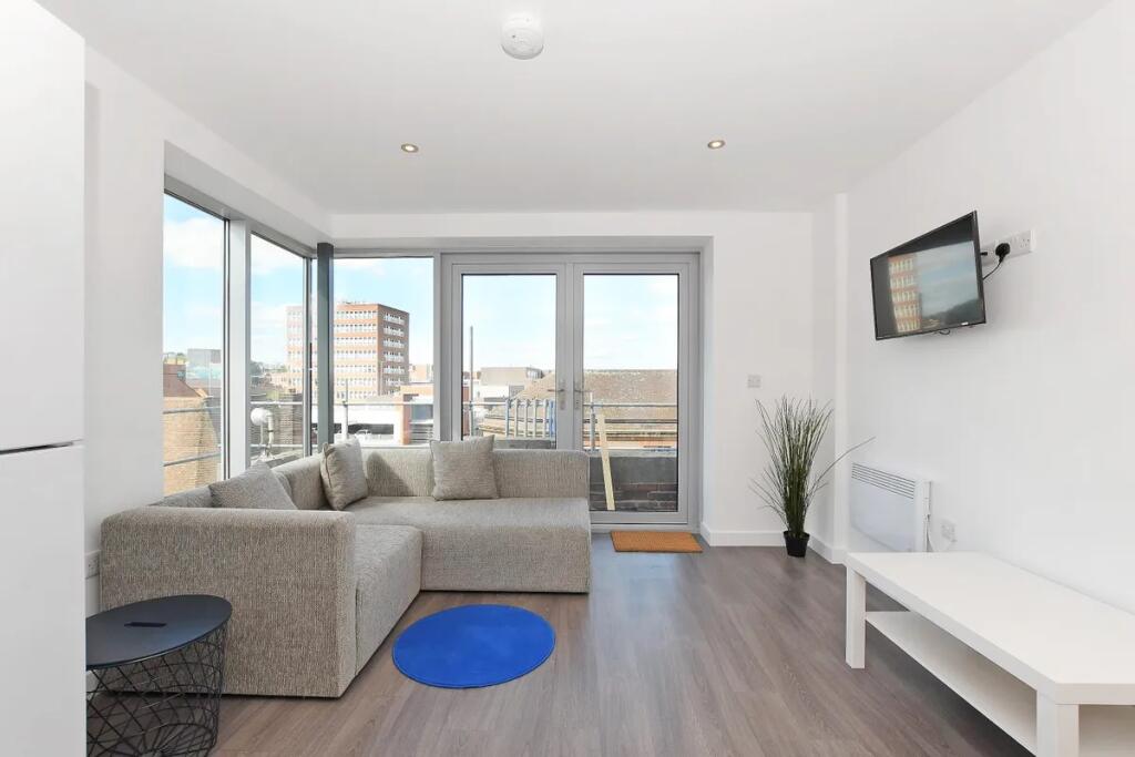 Bright and modern living room featuring large c...