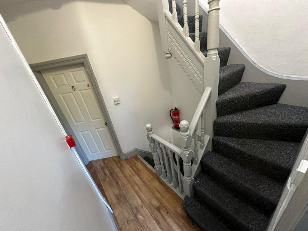 Bright, well-maintained entrance hallway with a...
