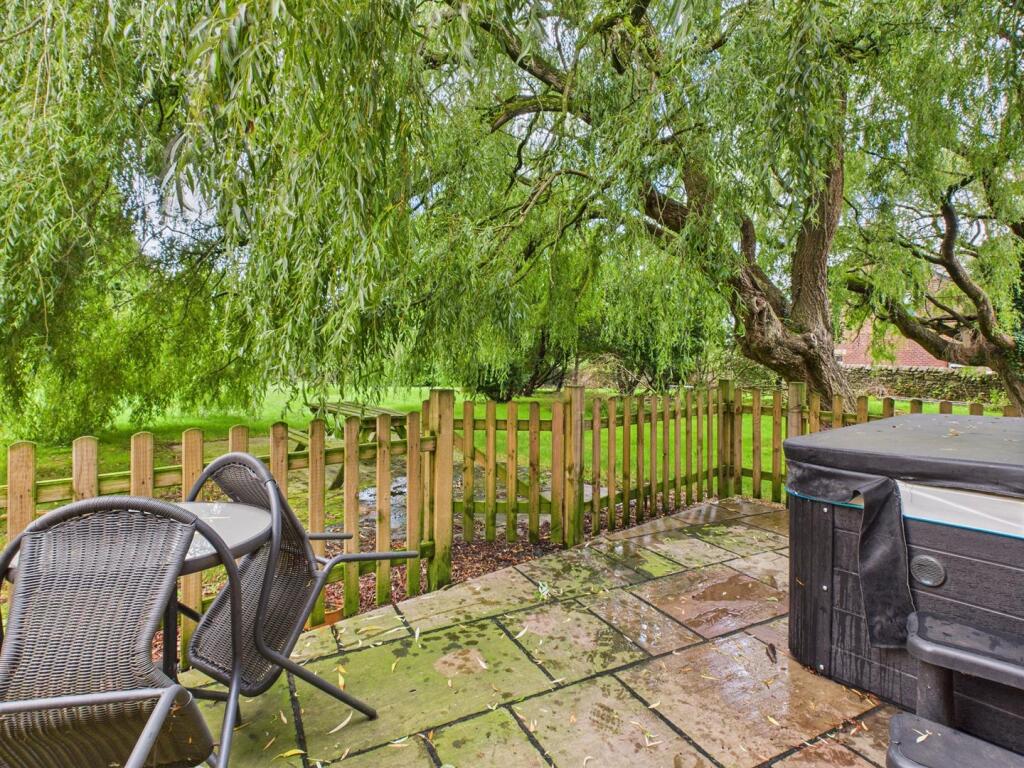 Courtyard with patio area and hot tub.