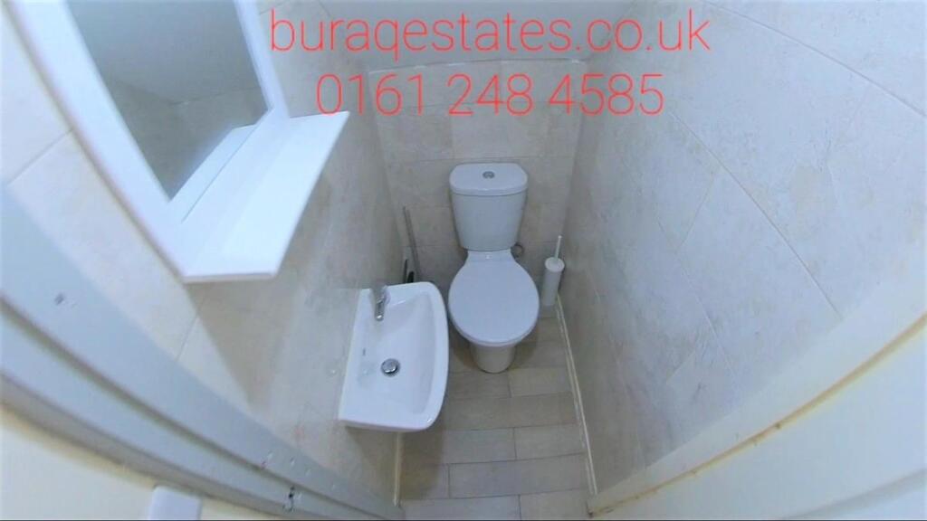 Compact tiled WC with a close-coupled toilet, s...