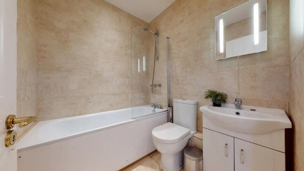 Modern bathroom suite featuring a clean white b...