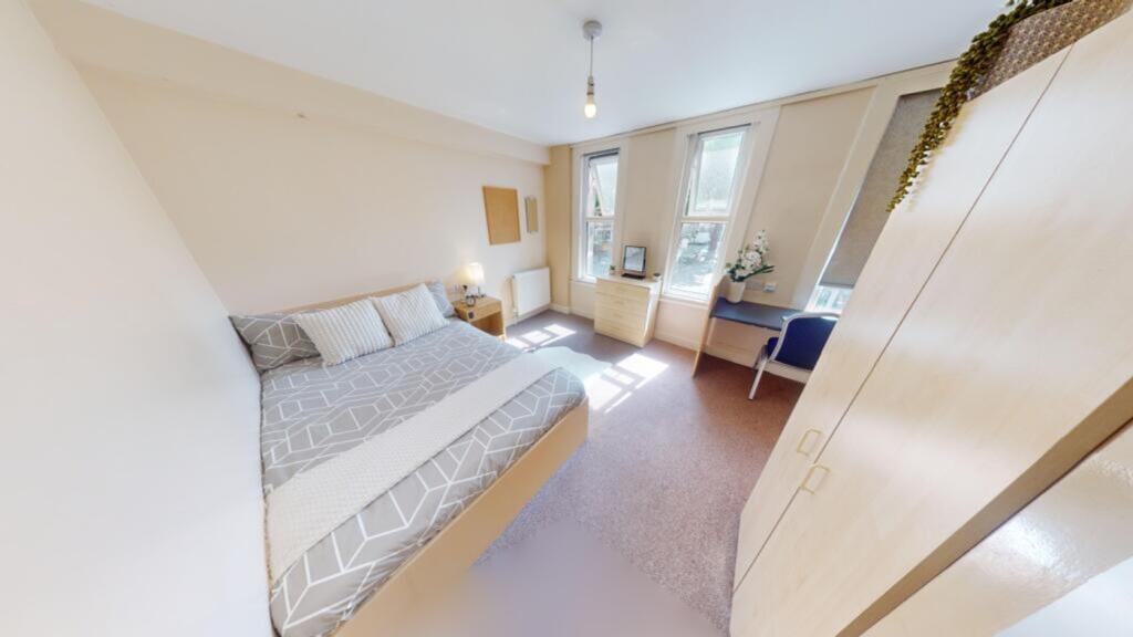 A bright and spacious double bedroom with ample...