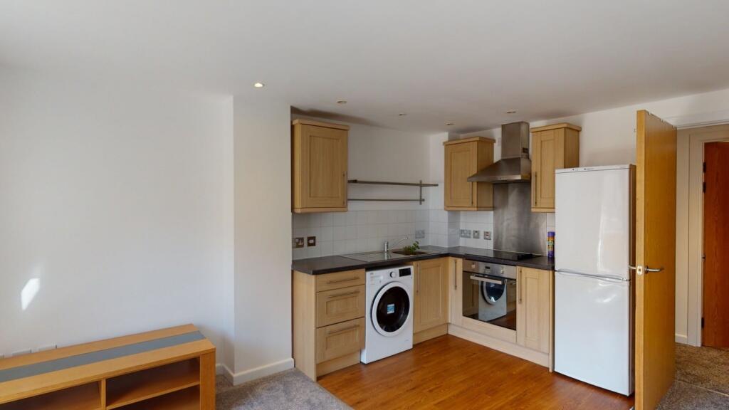 Bright and clean kitchen featuring modern appli...