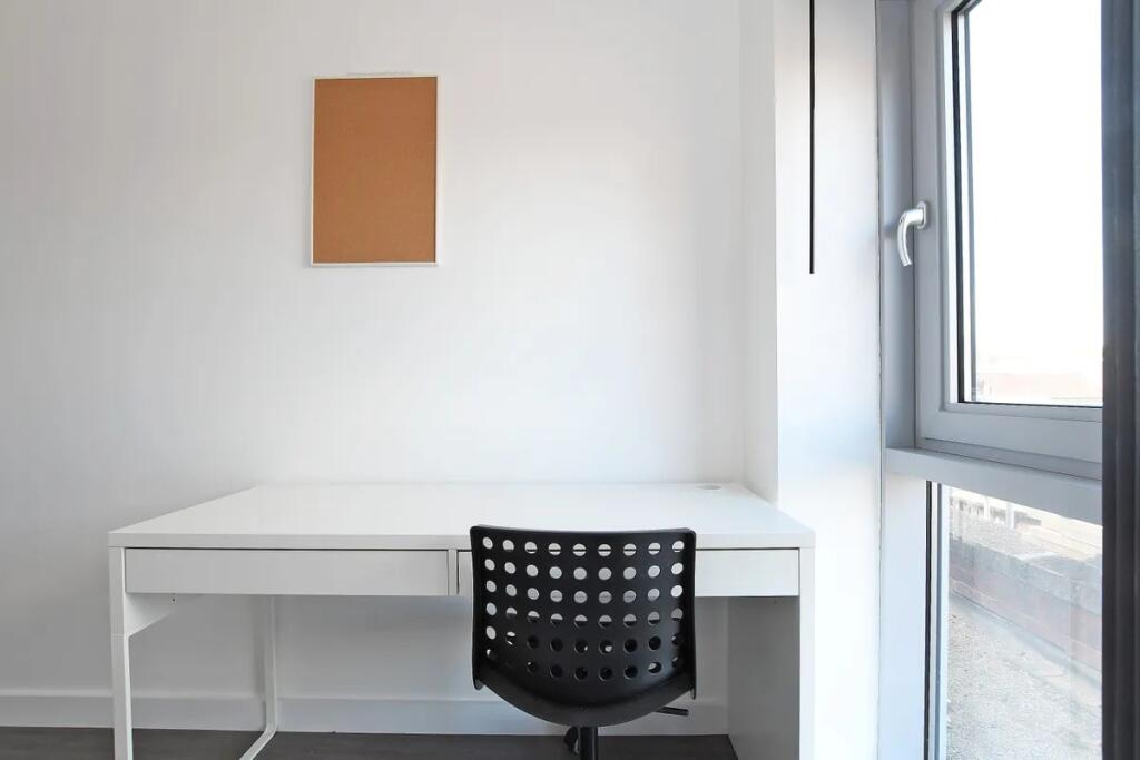 A clean and bright study area featuring a moder...