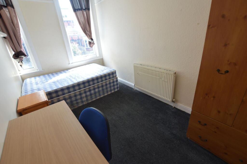 Bright single bedroom featuring two large windo...