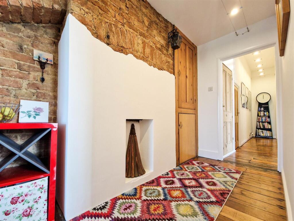 Hallway with exposed brick feature wall
