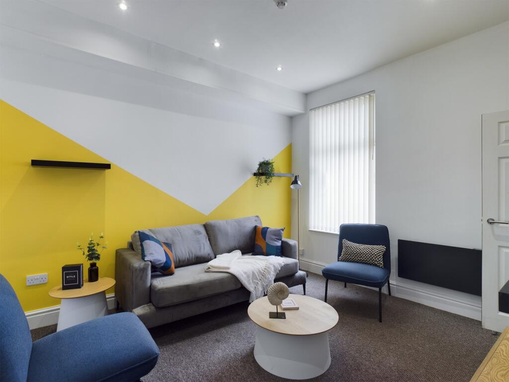 A stylish and spacious modern living room, perf...