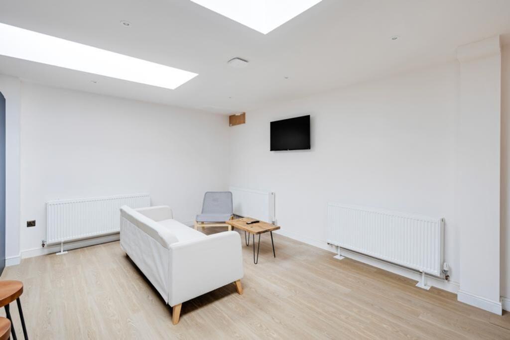 A bright and clean living room featuring a mode...