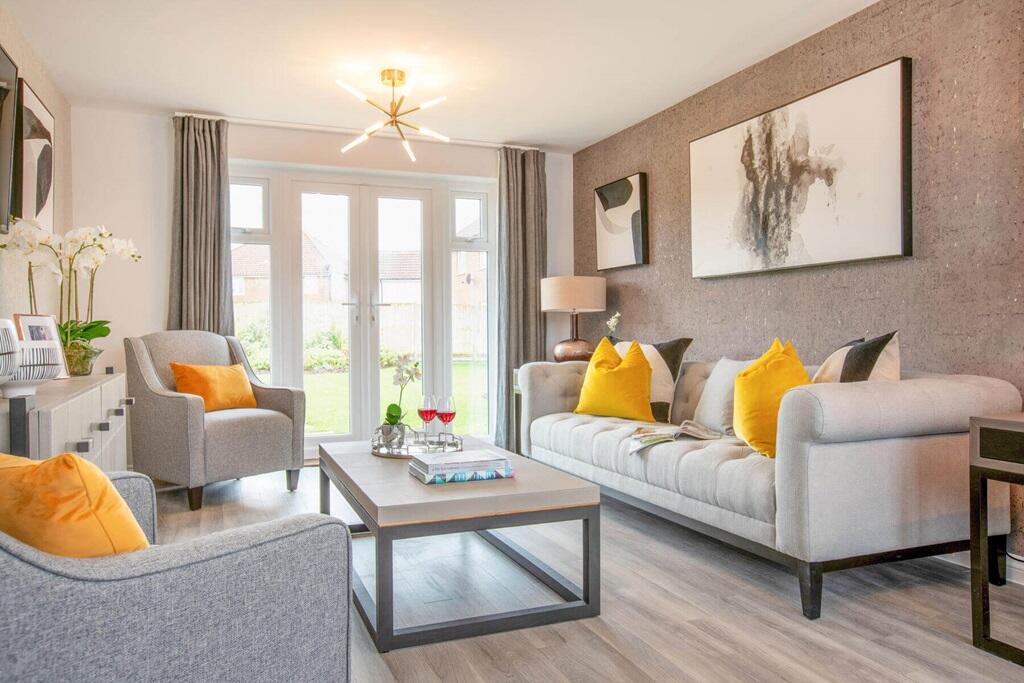 A bright and airy lounge features double doors to the garden