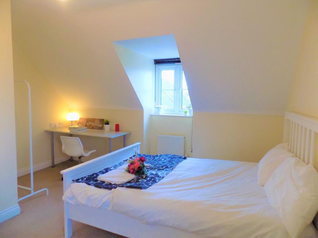 Bright and cozy double bedroom featuring a comf...