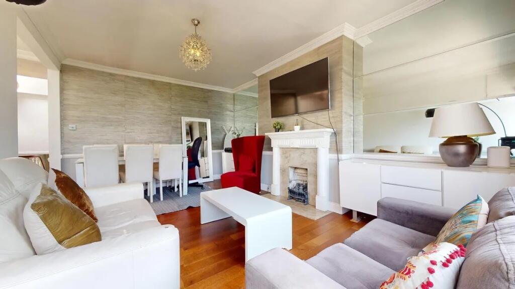 A stylish and inviting living room featuring co...