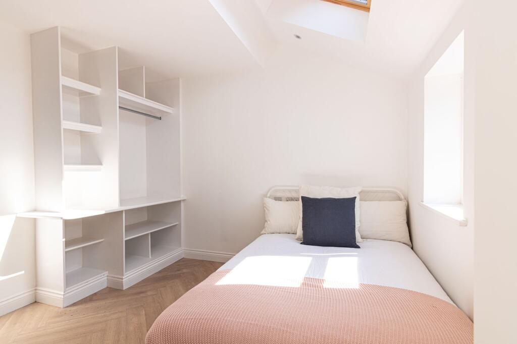 A bright and airy double bedroom featuring a co...