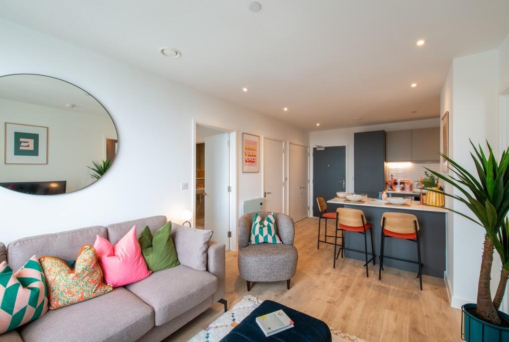 Bright and modern living room with stylish grey...