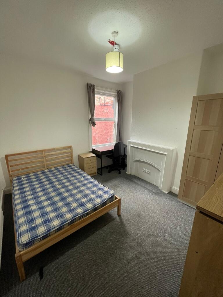 A spacious and inviting double bedroom with amp...