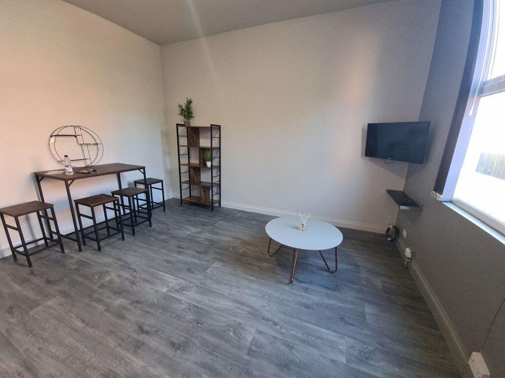 A modern living room featuring stylish grey flo...