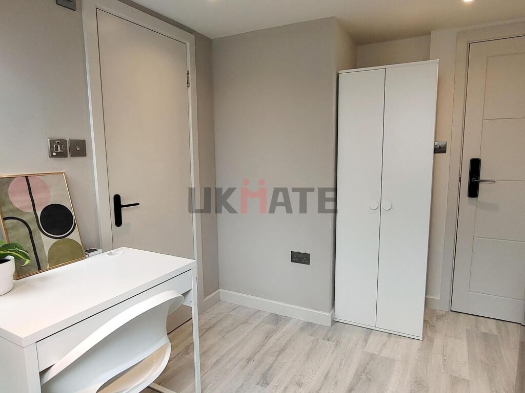 A bright and tidy bedroom featuring a white war...