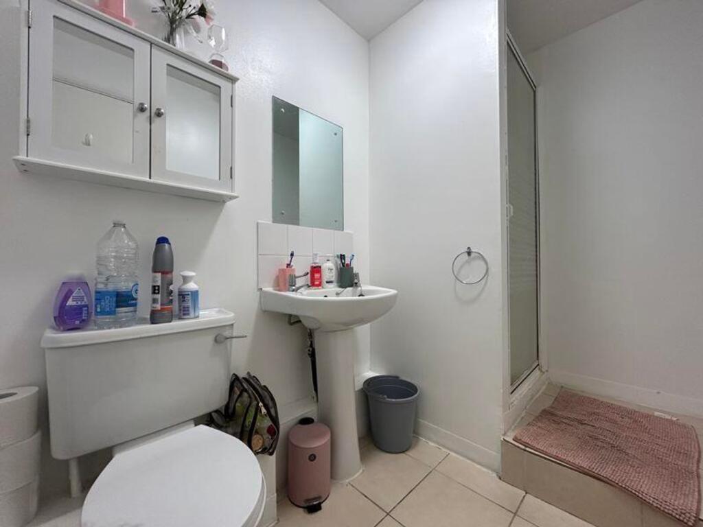 A clean and functional bathroom with a shower, ...