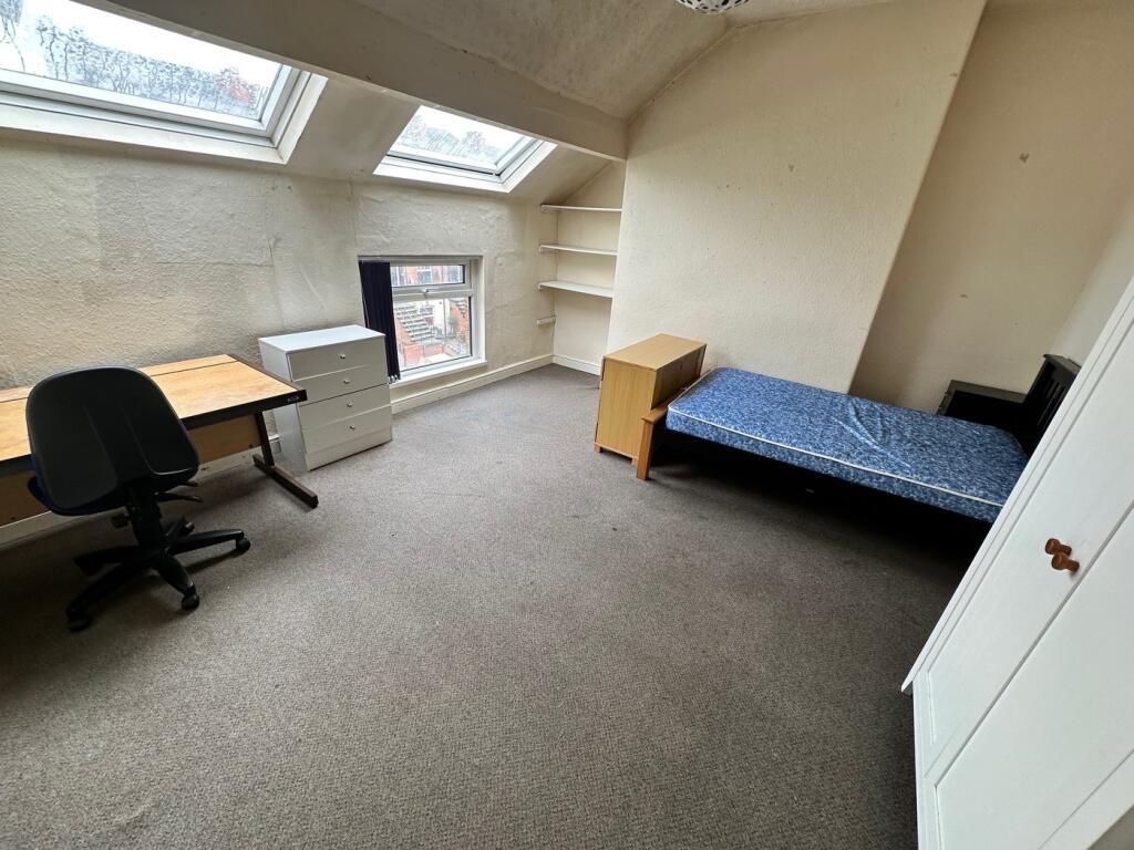 Spacious double bedroom featuring large windows...