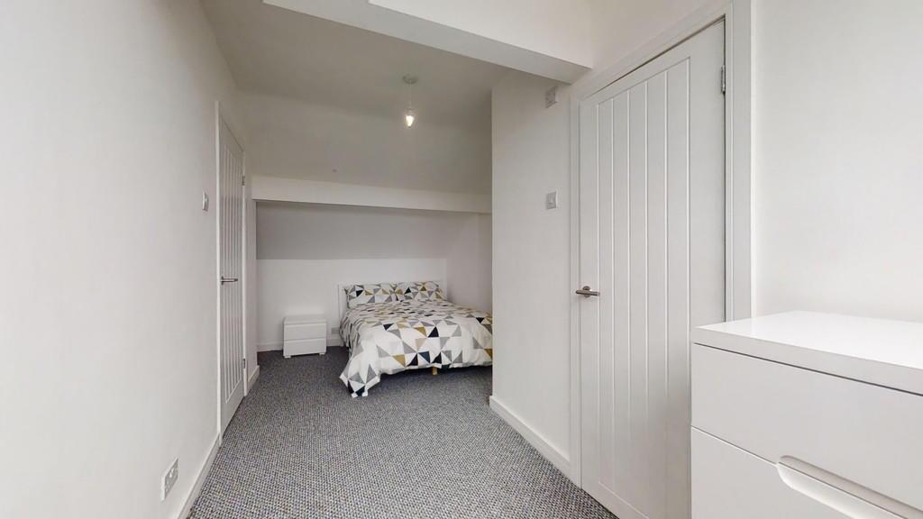 A clean and simple single bedroom featuring a c...