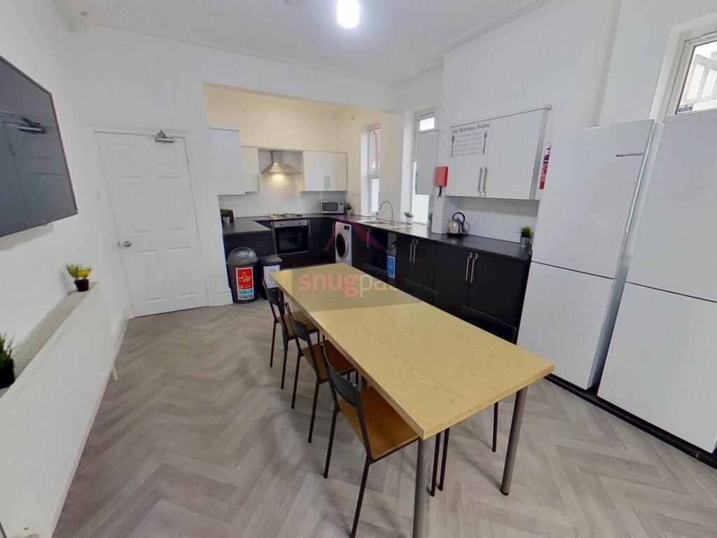 Modern kitchen with ample counter space, bright...