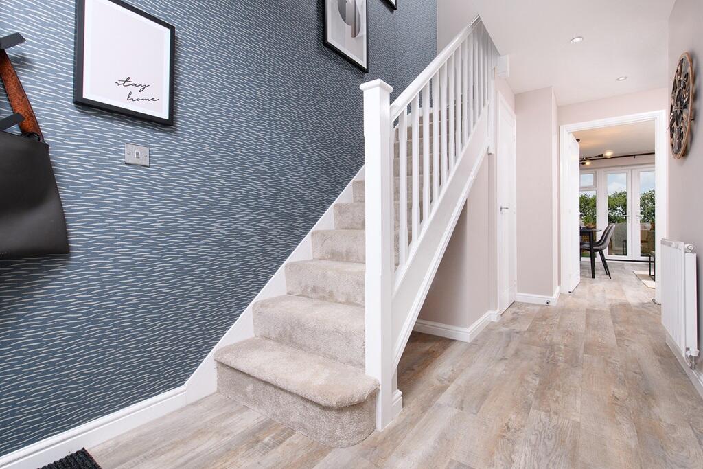 A welcoming hallway leads into the kitchen and lounge
