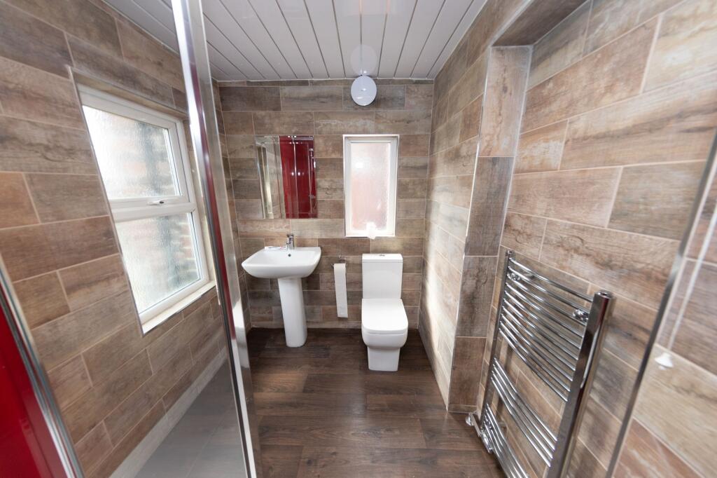 Modern bathroom featuring a white toilet and sm...