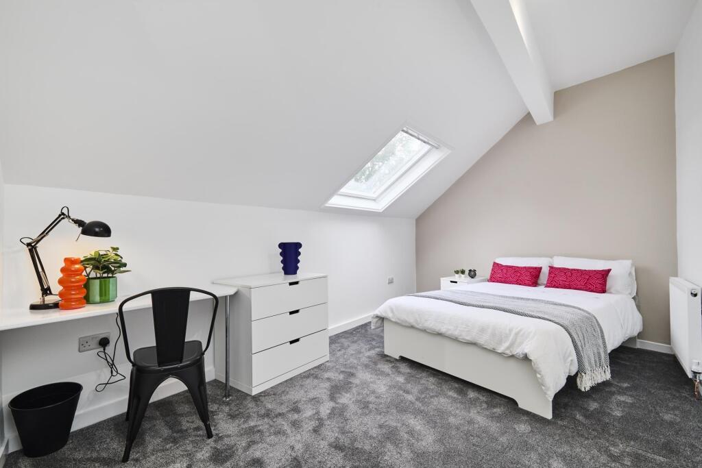 A bright and spacious master bedroom featuring ...