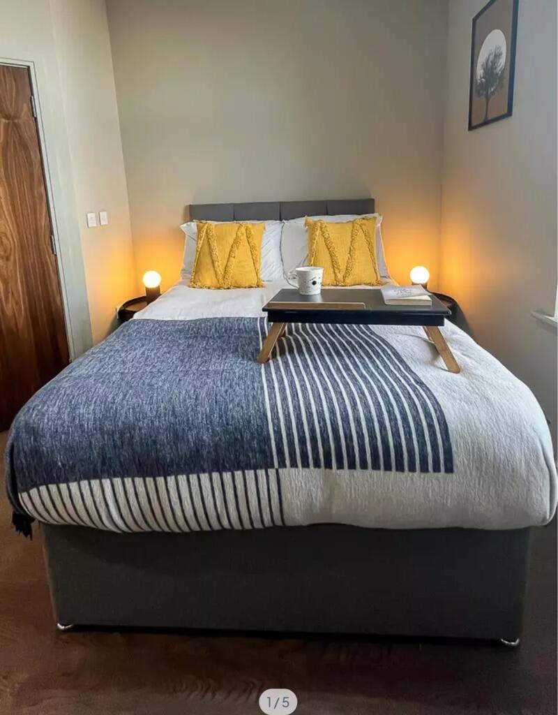 A stylish and inviting double bedroom featuring...