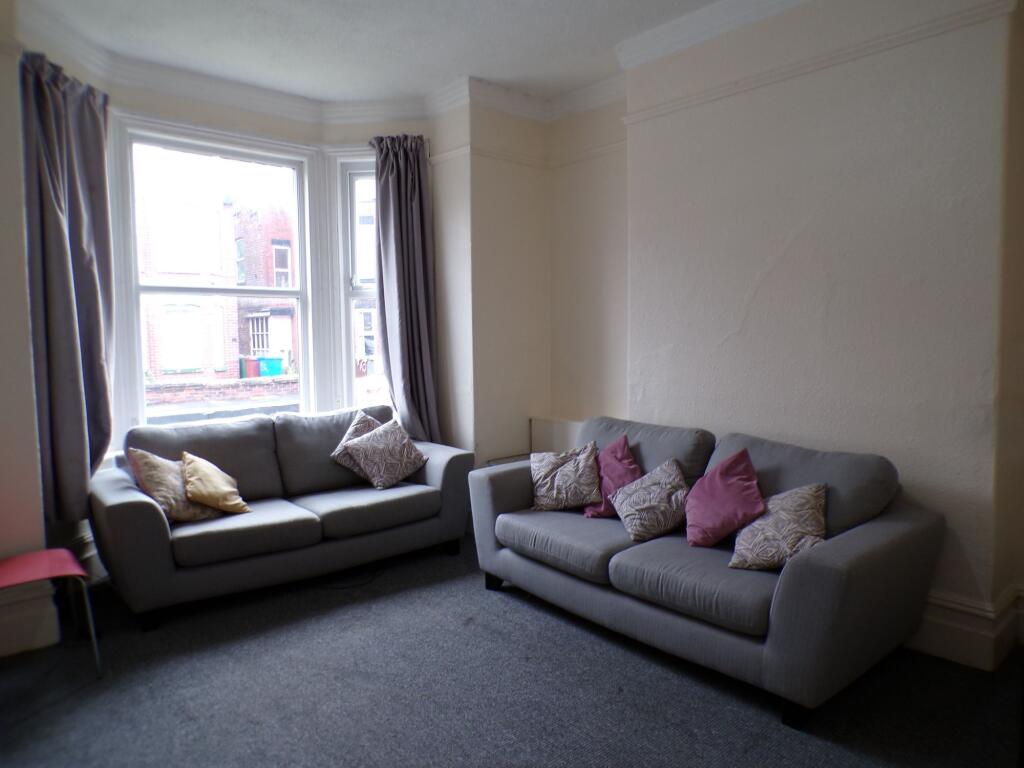 A spacious living room featuring two comfortabl...