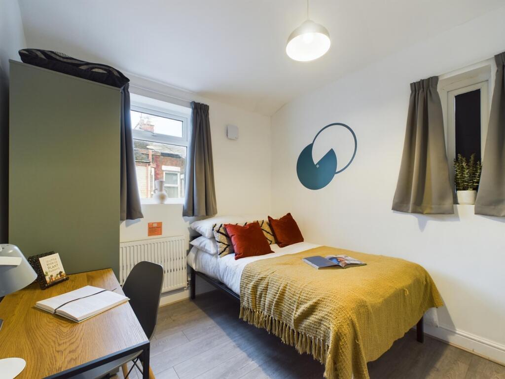 A bright and inviting double bedroom with moder...