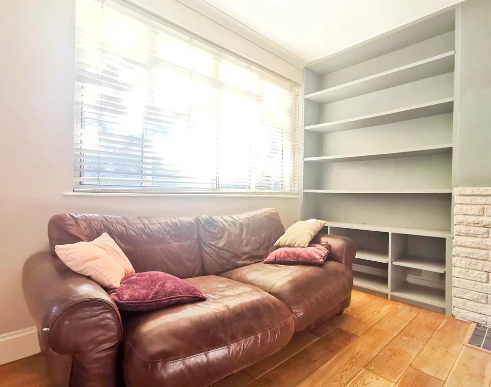 A cozy living room featuring a comfortable brow...