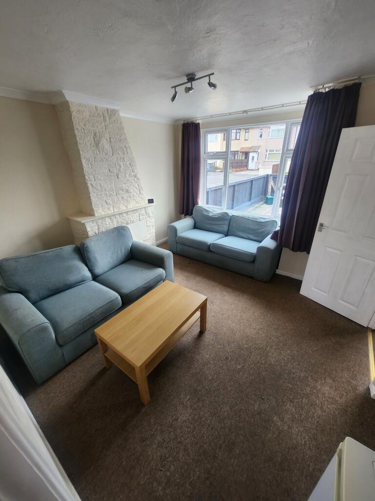 A cozy living room featuring two comfortable bl...