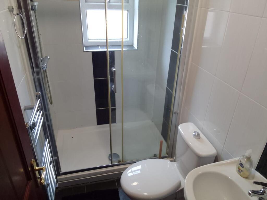 Bright and clean bathroom featuring a modern sh...