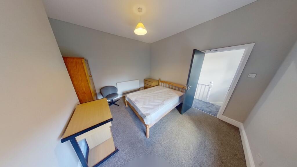 A bright and tidy double bedroom featuring a do...