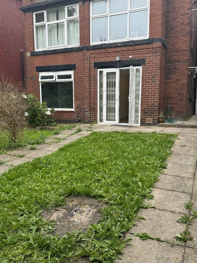 Front view of a classic red-brick terraced hous...