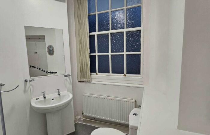 A clean and well-maintained bathroom with a whi...