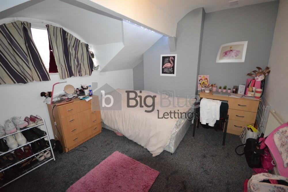 Cozy single bedroom featuring a comfortable bed...
