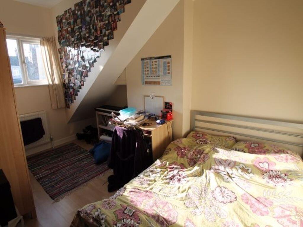 Bright double bedroom featuring a comfortable b...