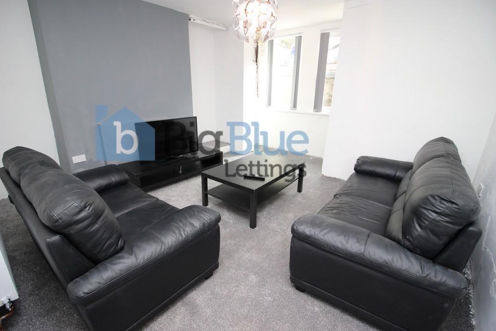 Comfortable and modern living room featuring bl...
